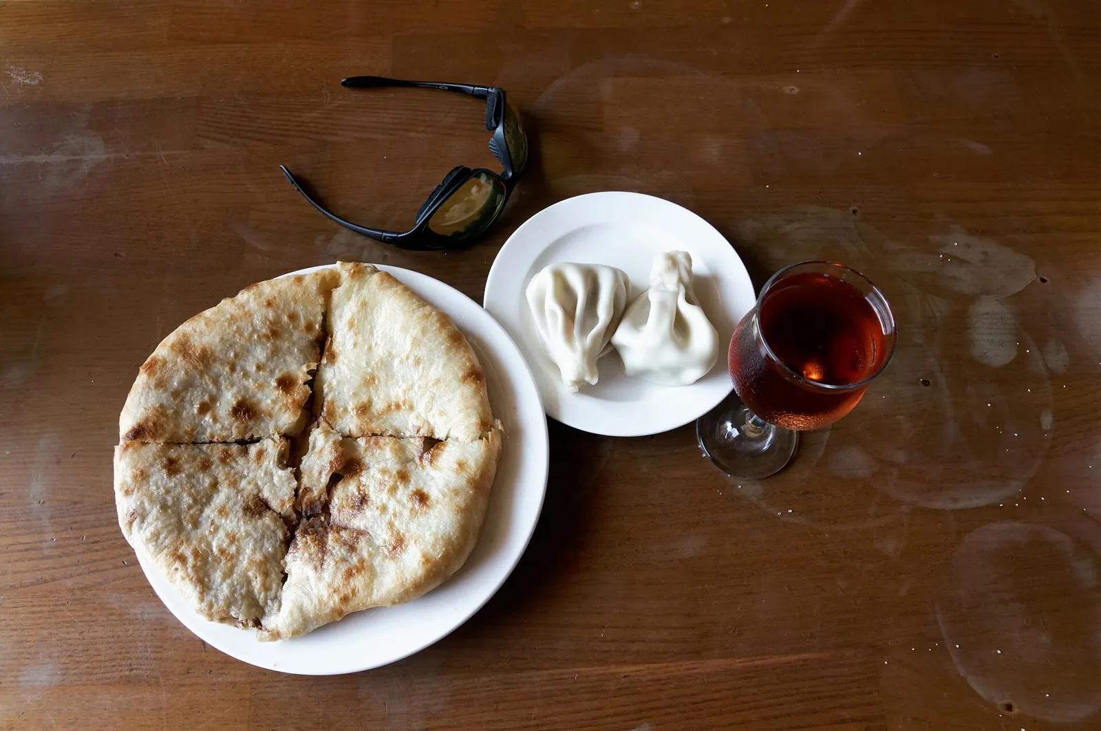 Khachapuri cheese bread and khinkali dumplings on a table in Tbilisi