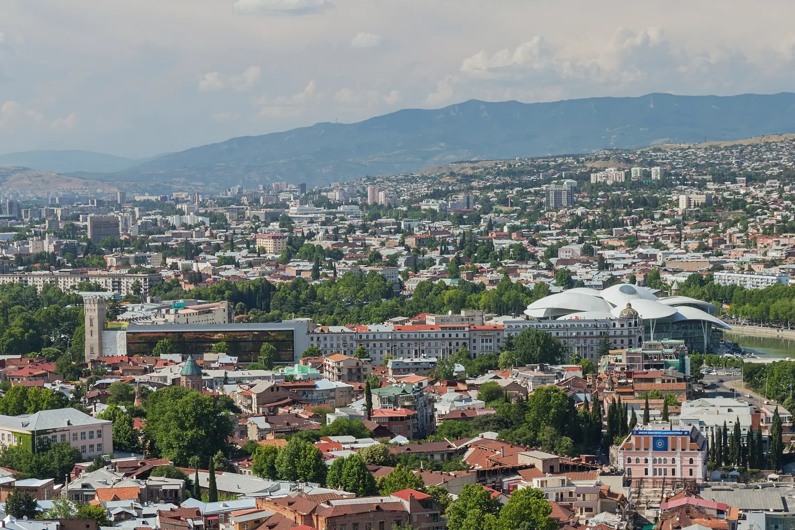 View over Tbilisi from Narikala Fortress, with the old town rooftops, the river and green hills beyond